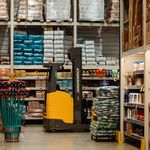 A warehouse with stacked goods, shelves, and a forklift in Brazil.