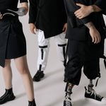 Fashion-forward individuals wearing prosthetics and contemporary outfits.