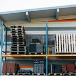 Neatly stacked building materials in a warehouse setting, showcasing construction organization.