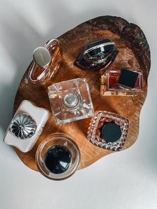 Stylish arrangement of luxury perfume bottles on a wooden tray, perfect for beauty theme.